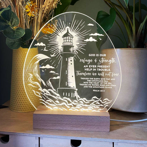 Psalm 46 1 - 3 God is our refuge and strength light design - Birch and Tides. Lighthouse surrounded by crashing waves engraved light design with the verse Psalm 46:1-3