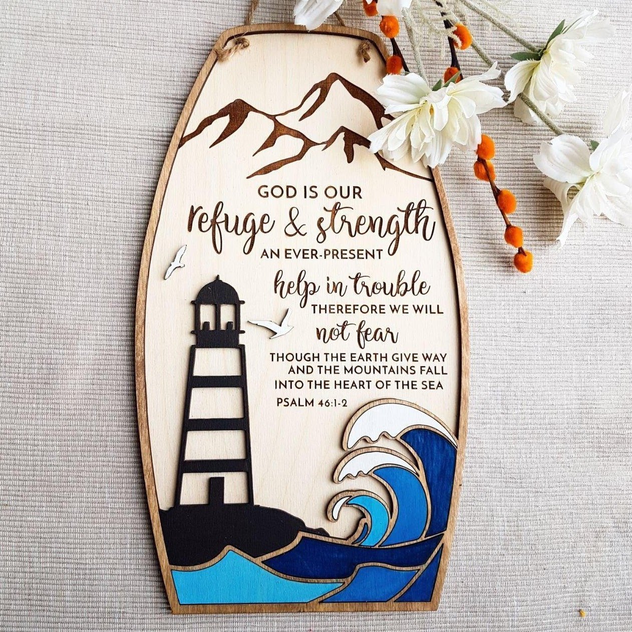 Encouraging scripture sign Psalm 46:1-3 with ocean and lighthouse theme