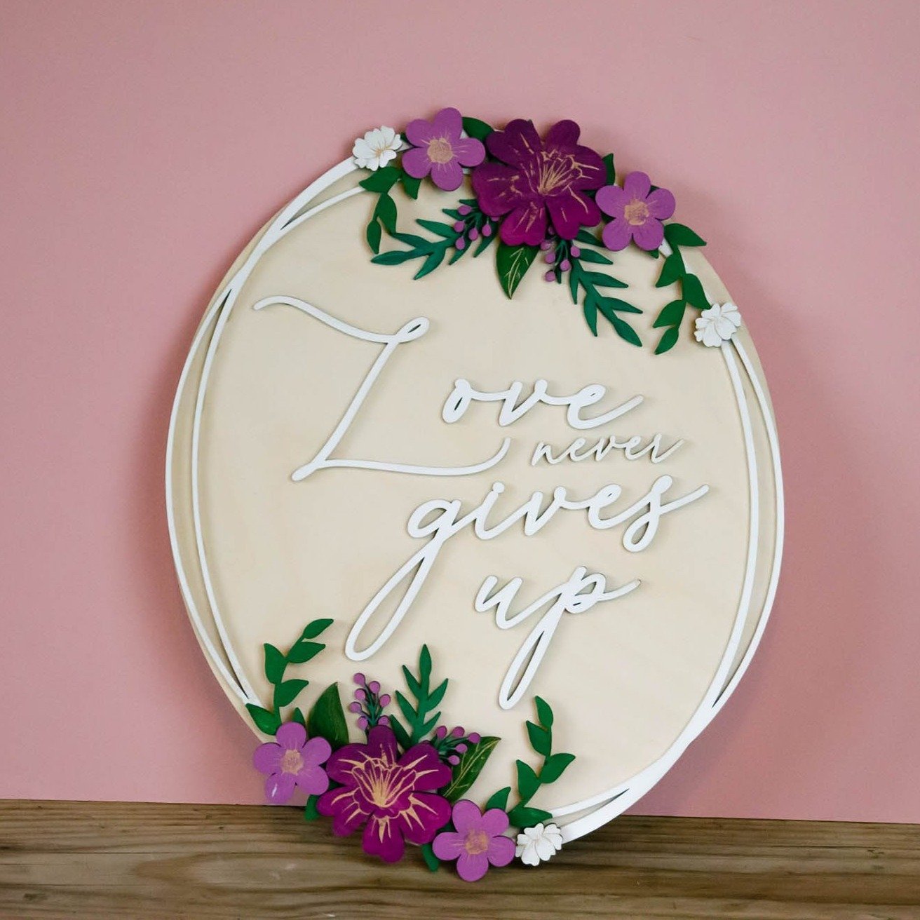 Love never gives up wooden wall sign